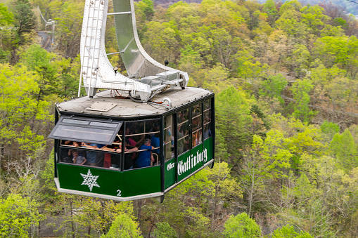 Gatlinburg, TN; April 16, 2017: Ober Gatlinburg cable car traveling down mid-air.