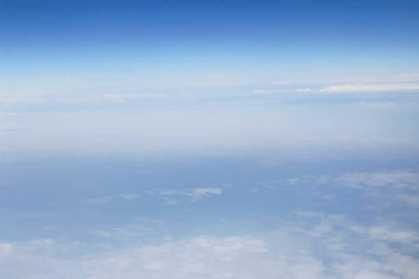 istock blue sky high view from airplane clouds shapes 678355154