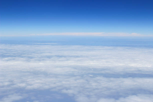 istock blue sky high view from airplane clouds shapes 678361230