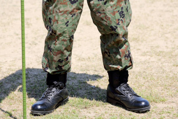 Soldier standing with  boots stock photo