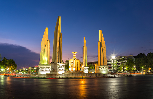 Democracy monument, landmark in capital and roundabout of traffic, of historical with sunset time in Bangkok Thailand