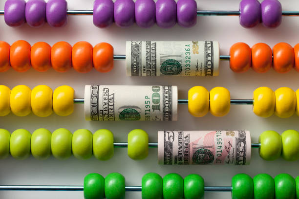Abacus with rolls of dollar banknotes.