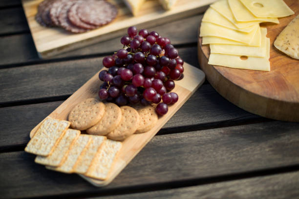 istock Red grapes with cookies and cheese on wooden table 678413232