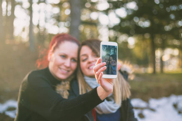istock Beauty girls having fun outdoors. Beautiful joyful blowing soap bubbles in spring park. Girlfriends outdoor. Friendship 678434620