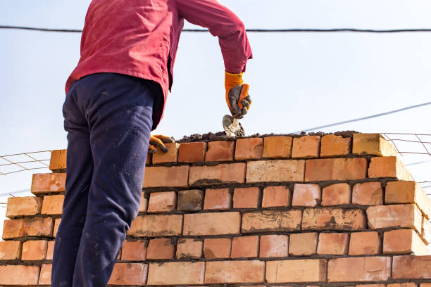 istock Worker builds a brick wall in the house 678443600
