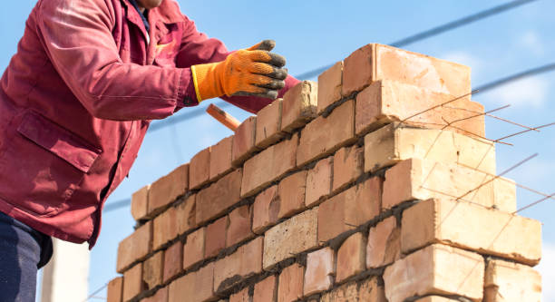 istock Worker builds a brick wall in the house 678444398