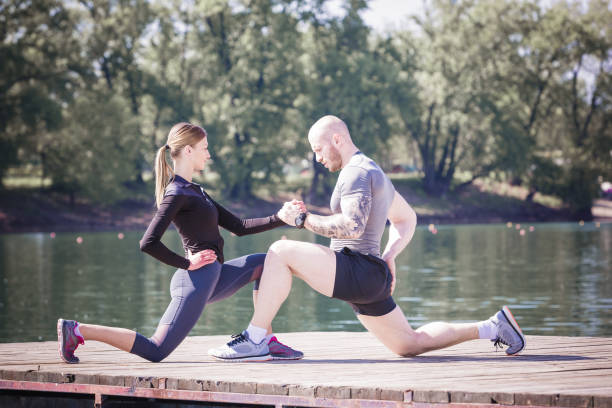 istock Happy young couple supporting together and doing stretching by the river before running. Ada lake, Belgrade, Serbia, Europe 678449198