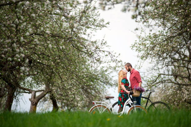 istock Loving young couple with bicycles in spring garden 678454182