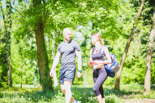 istock Young athlete couple preaparing for outdoors  workout in public park. 678455298