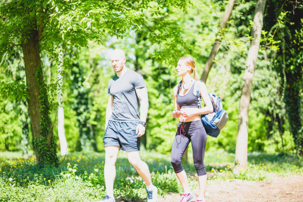 istock Young athlete couple preaparing for outdoors  workout in public park. 678455354