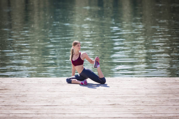 istock Young sporty girl doing stretching exercise in nature. 678455912