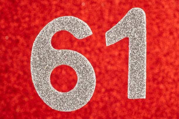 istock Number sixty-one silver color over a red background. Anniversary. 678462194