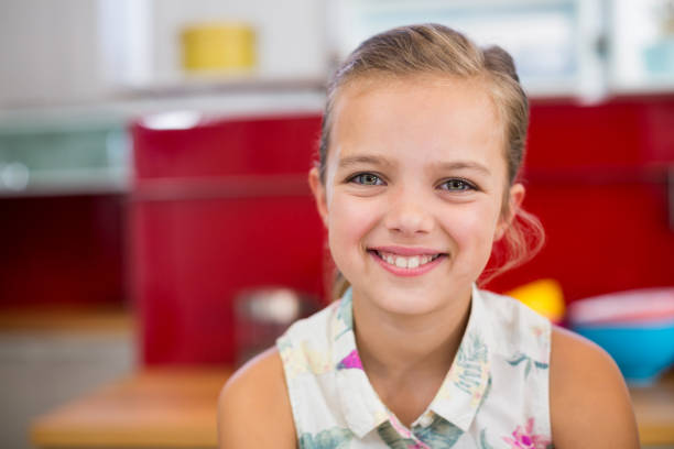 istock Girl smiling at camera at home 678465560