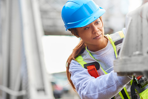 female site engineer conducting repairs on steel bridge