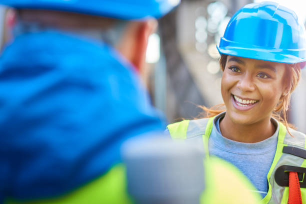 istock female engineer talks to colleague 678480630