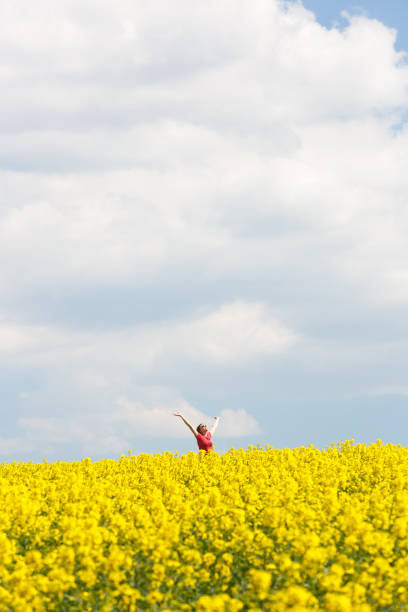 istock Woman with arms raised high, enjoying freedom 678486840