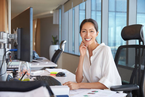 istock Portrait Of Businesswoman At Office Desk Using Computer 678500730