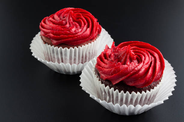 Red velvet cup cakes on black background - horizontal image
