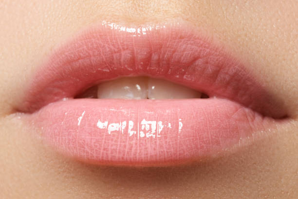 istock Beautiful full pink lips. Lipstick. Professional make-up 678507484