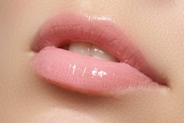 istock Beautiful full pink lips. Lipstick. Professional make-up 678507530