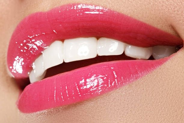 istock Macro happy woman's smile with healthy white teeth, pink lips 678507686