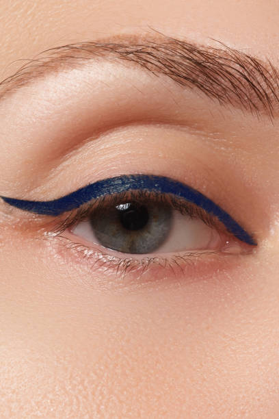 istock Beautiful model applying eyeliner close-up on eye. Make-up 678507886