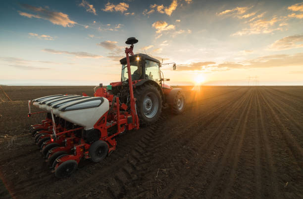 istock Farmer with tractor seeding - sowing crops at agricultural fields in spring 678508278