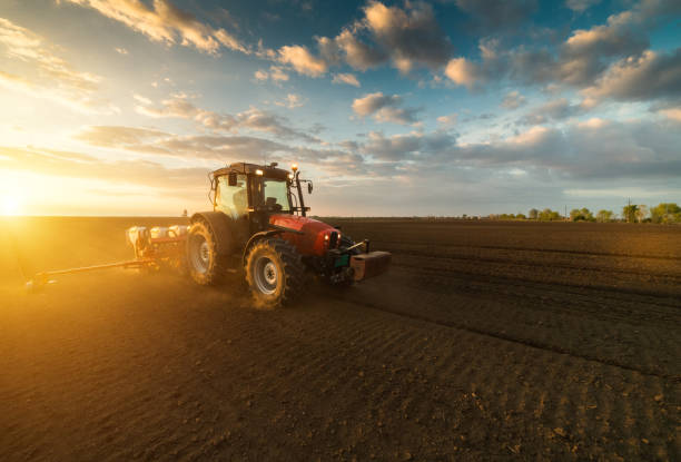 istock Farmer with tractor seeding - sowing crops at agricultural fields in spring 678508742