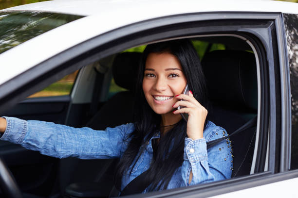 istock Smiling woman in the car and calling 678513108