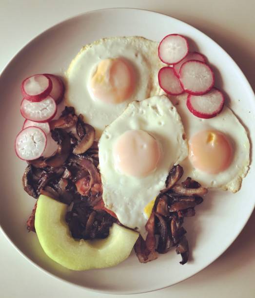 Breakfast: cooked eggs with mushrooms, radish and melon