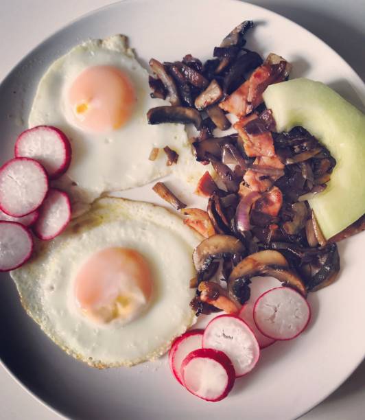 Breakfast: cooked eggs with mushrooms, radish and melon