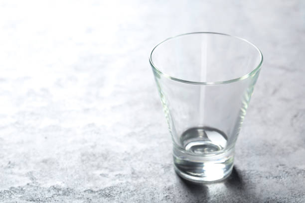 istock Empty glass on a grey wooden table 678532746