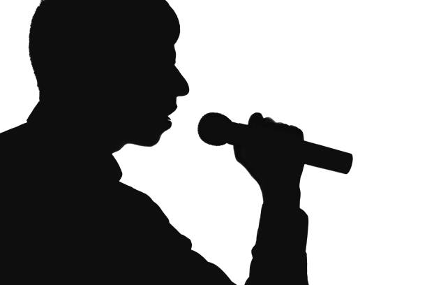 istock Silhouette of a man singing into a microphon 678535352