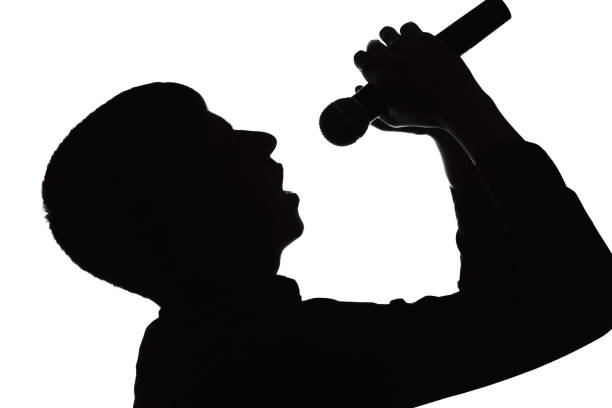 istock Silhouette portrait of a man sings into a microphone 678535882
