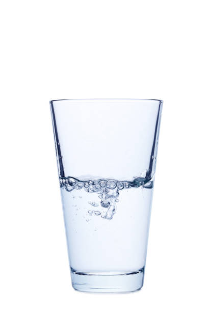 istock Water pouring in glass isolated on a white 678536052