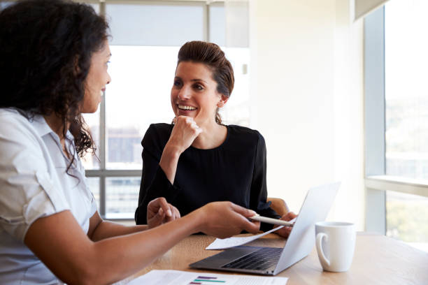 istock Two Businesswomen Using Laptop Computer In Office Meeting 678549316