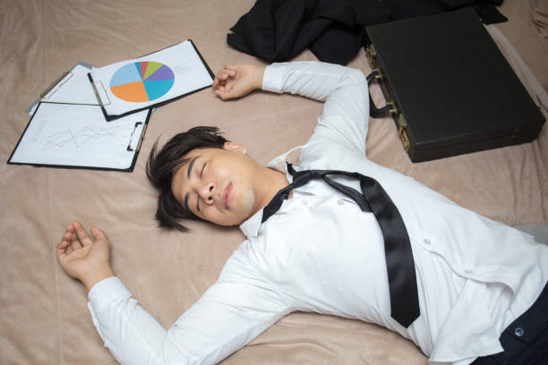 asian businessman is deep sleeping in his bed at night. businessman tired concept. - unfinish imagens e fotografias de stock