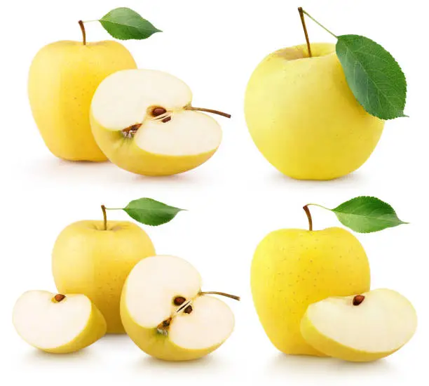 Photo of Set of ripe yellow apple fruits with green leaves on white