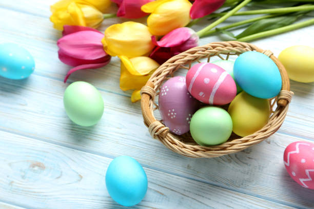istock Easter eggs with tulips on a blue wooden table 678562098