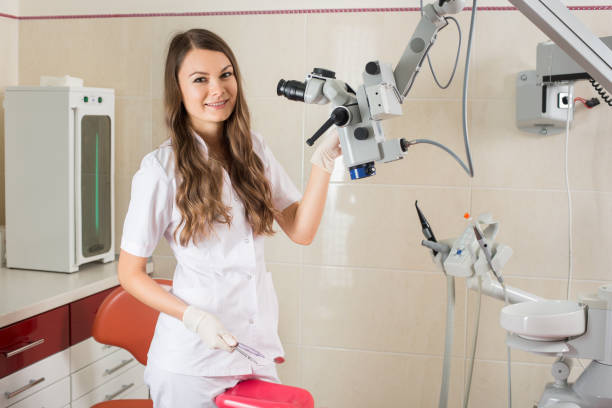 istock Attractive female doctor with microscope in the modern dentist office 678583086