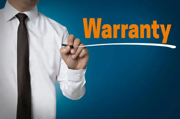 Warranty is written by businessman background concept.