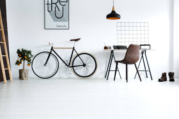 Simple, white room with bike Simple, white room with bike, desk, chair, lamp, ladder, poster door panel stock pictures, royalty-free photos & images