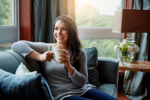 Shot of an attractive young woman relaxing at home