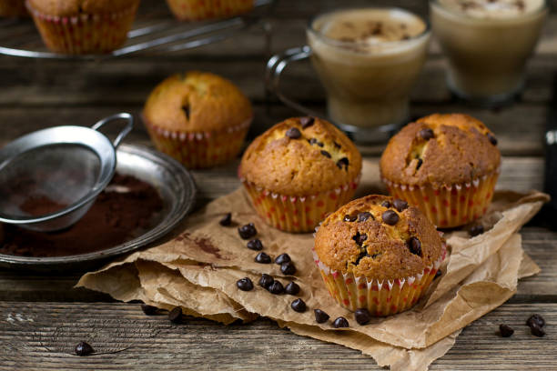 istock Chocolate chips muffins on wooden background 678596172