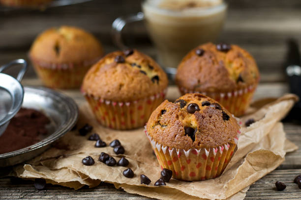 istock Chocolate chips muffins on wooden background 678596182