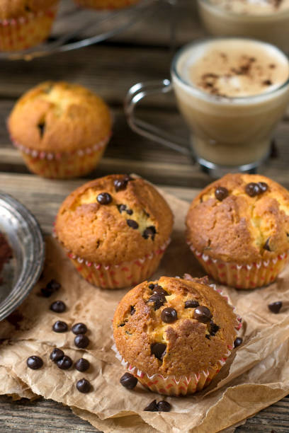 istock Chocolate chips muffins on wooden background 678596212