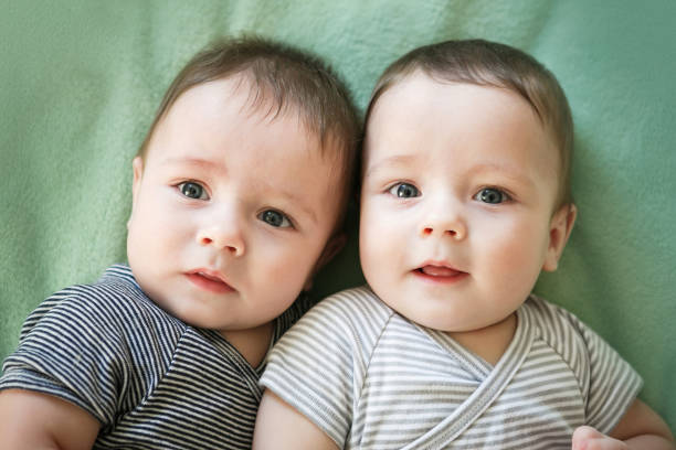 istock Newborn twins boys are lying on the bed 678603448