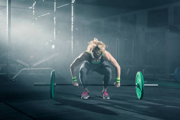 istock Female bodybuilder doing exercise with weights in gym 678603984