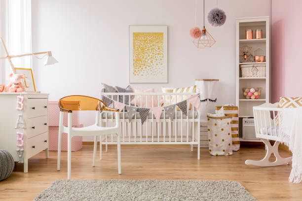 Baby bedroom with white chair Baby bedroom with white chair, cot, dresser, cradle and bookcase door panel stock pictures, royalty-free photos & images