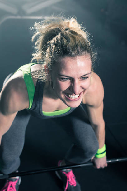 istock Female bodybuilder doing exercise with weights in gym 678607330